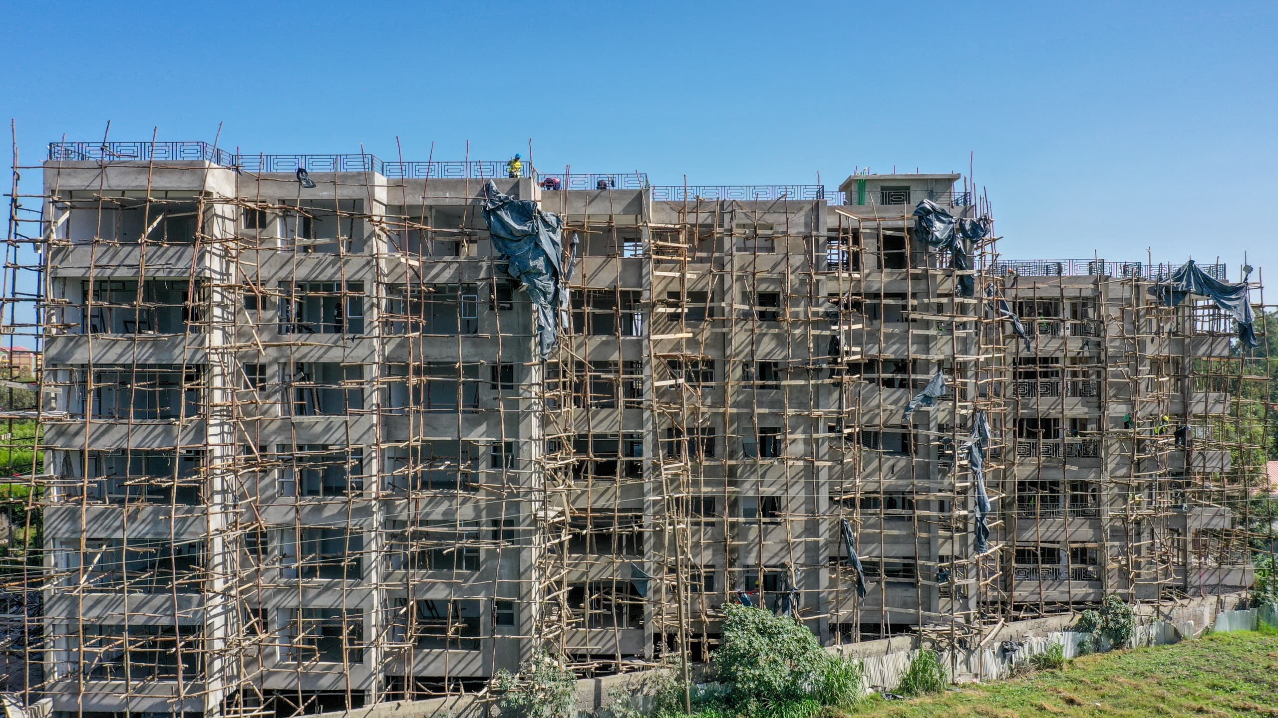 Naples by KCiti upper floors under full scaffolding, March 2026